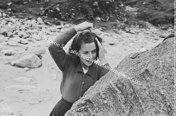 AT THE BEACH GIRL COMBING HER HAIR